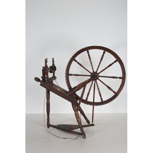 633 - A PINE AND PAINTED SPINNING WHEEL of typical form 87cm (h) x 93cm (w) x 43cm (d)