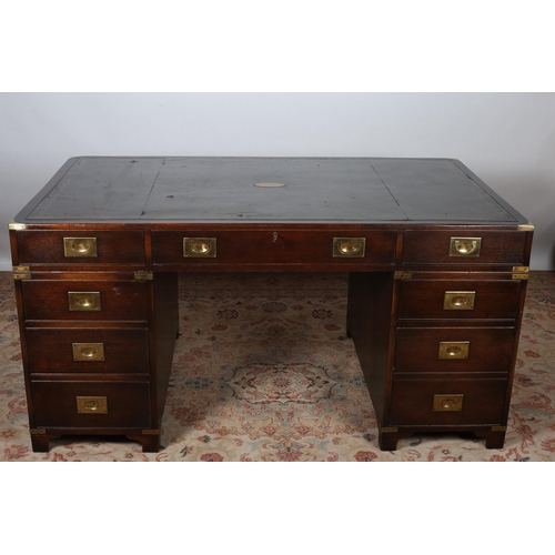 79 - A GOOD VINTAGE MAHOGANY AND BRASS BOUND MILITARY DESK of rectangular outline the shaped top with too... 