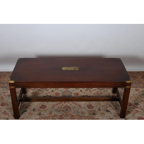 81 - A MAHOGANY AND BRASS BOUND COFFEE TABLE of rectangular form on square moulded legs joined by cross s... 