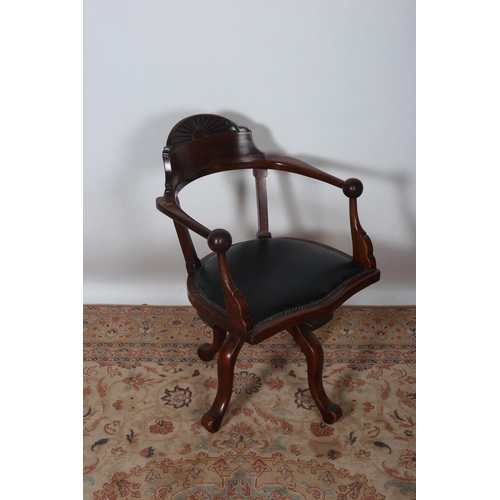 85 - A VINTAGE MAHOGANY SWIVEL OFFICE CHAIR the curved top rail and carved panel above an upholstered sea... 