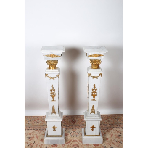 89 - A PAIR OF CONTINENTAL WHITE MARBLE AND BRASS MOUNTED PEDESTALS each of rectangular form the shaped t... 