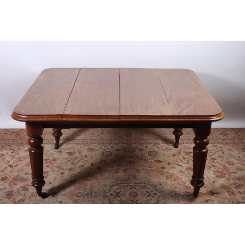 92 - A 19TH CENTURY MAHOGANY TELESCOPIC DINING TABLE of rectangular outline with rounded corners with two... 