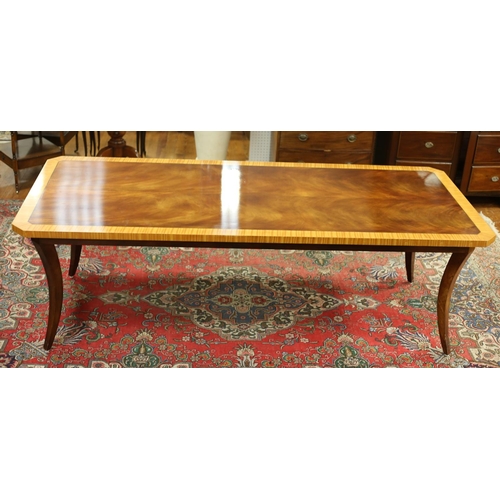 99 - A SHERATON DESIGN MAHOGANY AND SATINWOOD CROSS BANDED DINING TABLE of rectangular outline with cante... 