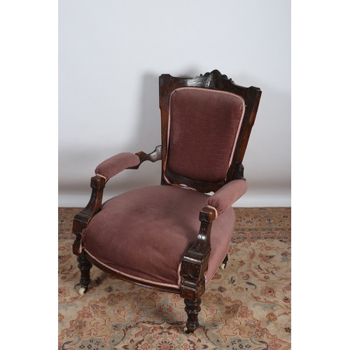 654 - AN EDWARDIAN CARVED MAHOGANY AND UPHOLSTERED ARMCHAIR the carved scroll top rail above an upholstere... 