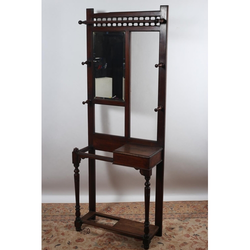 567 - A VINTAGE MAHOGANY HAT AND COAT STAND of rectangular outline with moulded rail above a bevelled glas... 