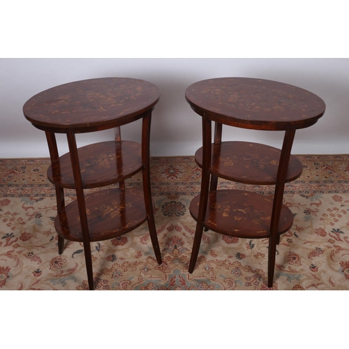 76 - A PAIR OF CONTINENTAL THREE TIER TABLES each of oval outline with floral decoration raised on moulde... 