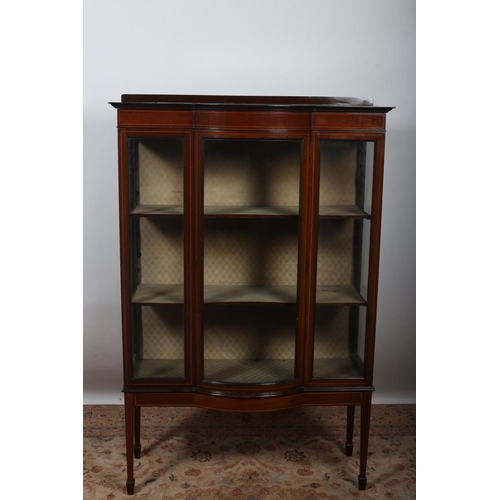 10 - A VINTAGE MAHOGANY DISPLAY CABINET of rectangular bowed outline with satinwood string inlay the shap... 