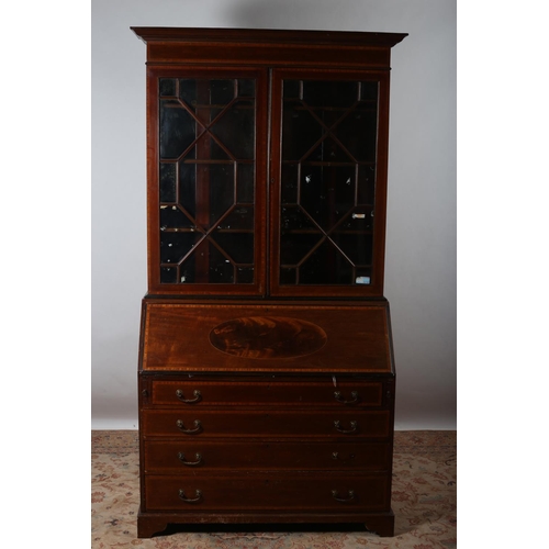 12 - A 19TH CENTURY MAHOGANY AND SATINWOOD CROSS BANDED BUREAU BOOKCASE the moulded cornice above a pair ... 