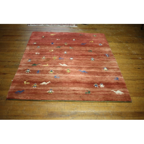 18 - A GABBEH WOOL RUG the light and dark pink ground with animals and figures 200cm x 136cm