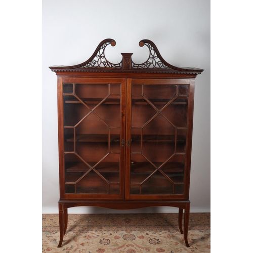 2 - A GEORGIAN MAHOGANY AND SATINWOOD INLAID BOOKCASE the pierced swan neck cornice above a pair of astr... 