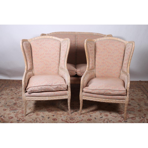 20 - A THREE PIECE CONTINENTAL LIMEWOOD SUITE comprising pair of tub shaped chairs with loose cushions an... 