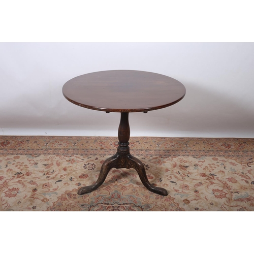 21 - A GEORGIAN MAHOGANY BREAKFAST TABLE the circular hinged top above a baluster column on tripod suppor... 