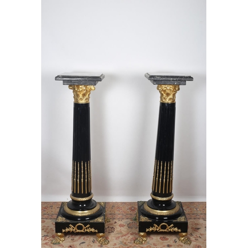 29 - A PAIR OF CONTINENTAL BLACK MARBLE AND PINE BLACK LACQUERED GILT BRASS MOUNTED PEDESTALS each with a... 