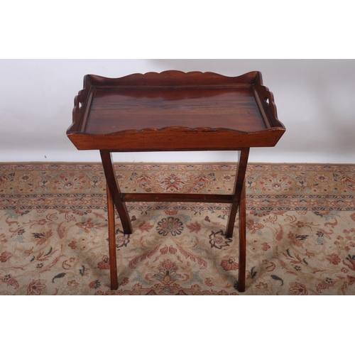 32 - A GEORGIAN DESIGN MAHOGANY TRAY of rectangular outline with pie crust gallery and pierced handles on... 