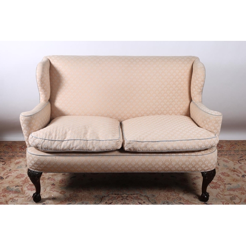 38 - A CHIPPENDALE DESIGN MAHOGANY AND UPHOLSTERED TWO SEATER WING BACK SETTEE the rectangular shaped bac... 