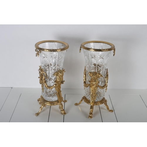47 - A PAIR OF CONTINENTAL GILT BRASS AND CUT GLASS VASES each hung with ribbon tied swags on hoof feet w... 