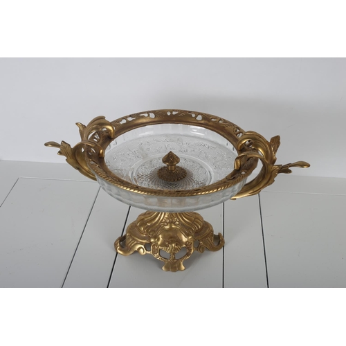 49 - A CONTINENTAL GILT BRASS AND CUT GLASS BOWL the pierced rim with foliate cast arms raised on an oval... 