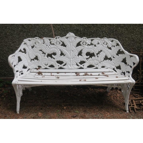 804 - A CAST IRON FERN BACK GARDEN SEAT with pine slatted seat on rustic legs 88cm (h) x 154cm (w)