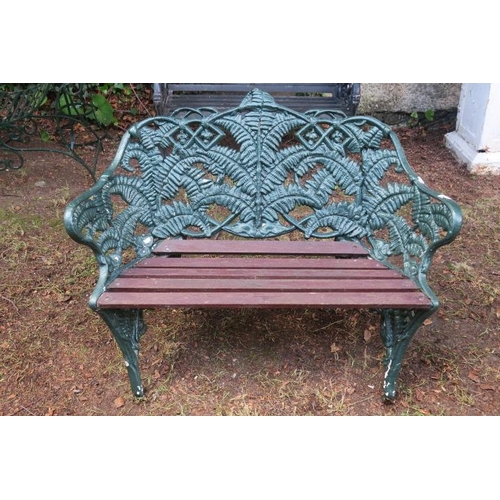 809 - A CAST IRON FERN BACK GARDEN SEAT with teak slatted seat on rustic legs 81cm (h) x 150cm (w) x 50cm ... 