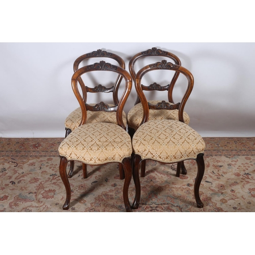 81 - A SET OF FOUR VICTORIAN MAHOGANY DINING CHAIRS each with a carved top rail and splat with upholstere... 