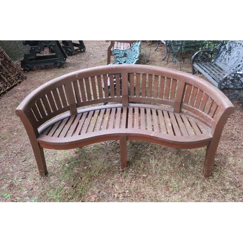 811 - A TEAK GARDEN BENCH of demilune outline the curved top rail above vertical splats with slatted seat ... 