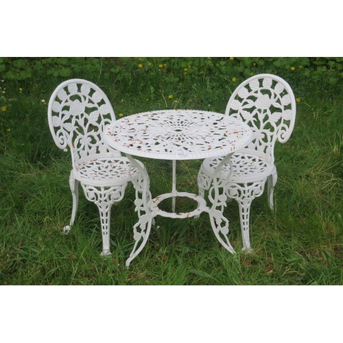 820 - A THREE PIECE CAST METAL PATIO SUITE comprising a circular table with pierced flowerhead and foliate... 