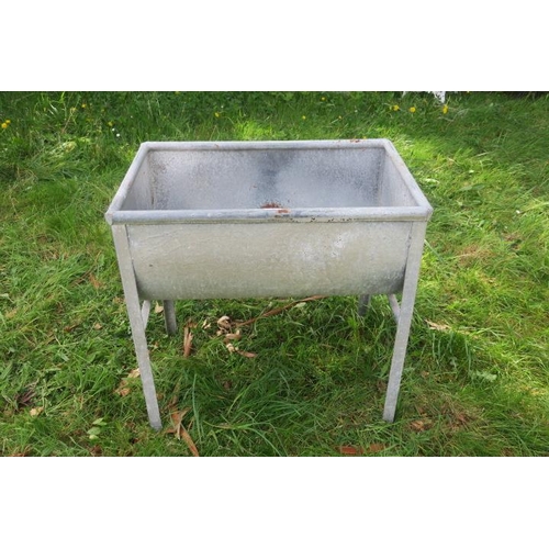 830 - A GALVANISED TROUGH of rectangular bowed outline with bung holes raised on moulded legs 83cm (h) x 8... 