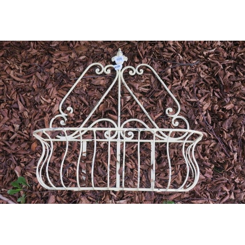 834 - A WROUGHT IRON WALL MOUNTED PLANTER of rectangular bowed outline with fleur de lis finials and scrol... 