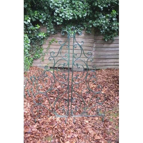 837 - A PAIR OF WROUGHT IRON SCREENS each with scroll decoration on scroll legs 132cm (h) x 115cm (w)