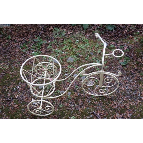 840 - A WROUGHT IRON PLANTER in the form of a three wheeled bicycle with scroll decoration 60cm (h) x 80cm... 