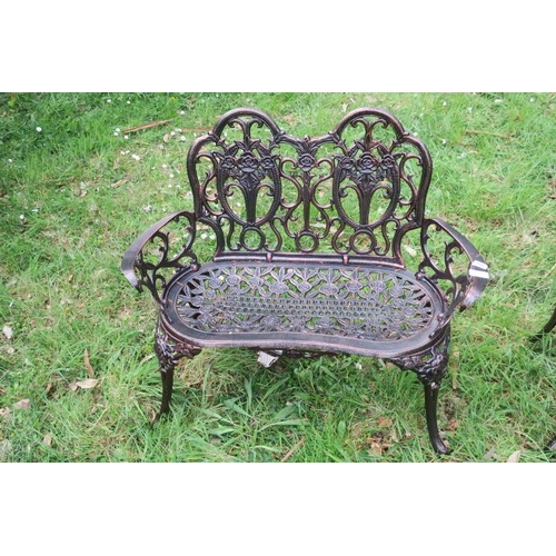 842 - A CAST METAL CHAIR BACK SETTEE with flowerhead and foliate pierced back and seat with scroll arms on... 