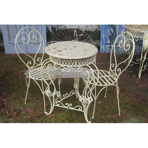 843 - A THREE PIECE WROUGHT IRON AND MARBLE PATIO SUITE comprising pair of chairs each with scroll decorat... 