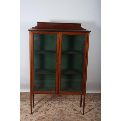 90 - A VINTAGE MAHOGANY DISPLAY CABINET of rectangular outline with moulded back above a pair of glazed d... 