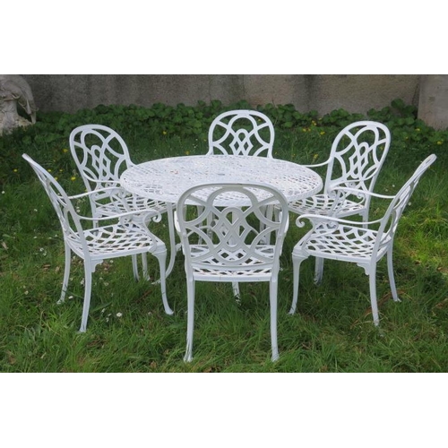 815 - A SEVEN PIECE CAST METAL PATIO SUITE comprising six elbow chairs each with a pierced intertwined spl... 