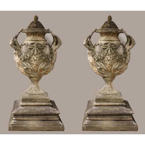 100 - A VERY FINE AND IMPRESSIVE PAIR OF SANDSTONE URNS each of ovoid tapering form hung with ribbon tied ... 