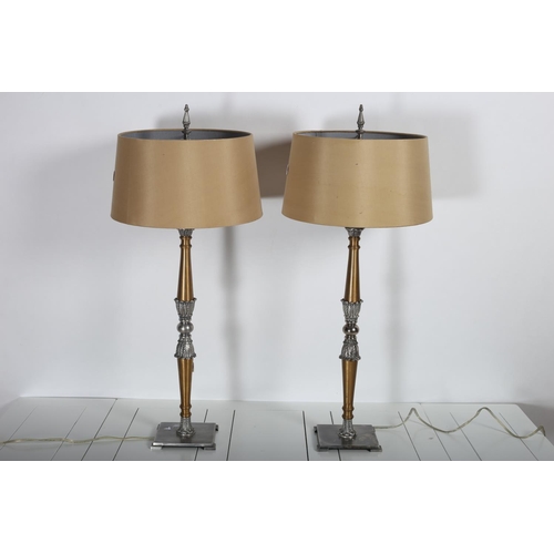 103 - A PAIR OF CONTINENTAL BRASS AND WHITE METAL TABLE LAMPS each with a foliate capped column raised on ... 