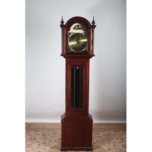 19 - A MAHOGANY LONG CASE CLOCK the rectangular arched hood containing a brass dial with Roman numerals i... 
