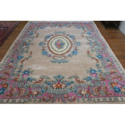 20 - A GOOD CHINESE WOOL RUG the beige and light pink ground with central panel filled with foliate and f... 