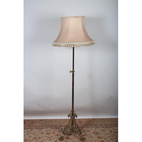 28 - A 19TH CENTURY BRASS TELESCOPIC FLOOR STANDING LAMP the cylindrical column raised on a pierced C-scr... 