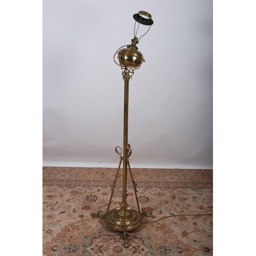 29 - A BRASS FLOOR STANDING OIL LAMP (now converted) the cylindrical column above a circular foot with cy... 