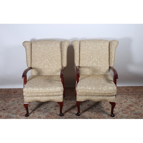 39 - A PAIR OF PARKER KNOLL DESIGN STAINED WOOD AND UPHOLSTERED WING CHAIRS with loose cushions and scrol... 