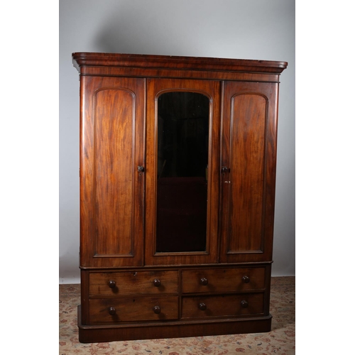 66 - A VICTORIAN MAHOGANY WARDROBE the moulded cornice above a central mirrored panel flanked by panelled... 