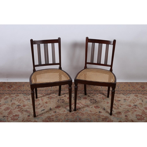 691 - A PAIR OF VINTAGE STAINED WOOD SIDE CHAIRS each with a curved top rail with vertical splats and cane... 