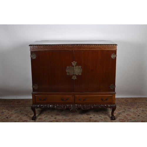 7 - A CHIPPENDALE DESIGN MAHOGANY SIDE CABINET of rectangular outline the shaped top with gadrooned rim ... 