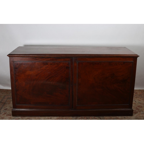 70 - A GEORGIAN MAHOGANY CUPBOARD of rectangular outline the shaped top above a pair of panelled doors co... 