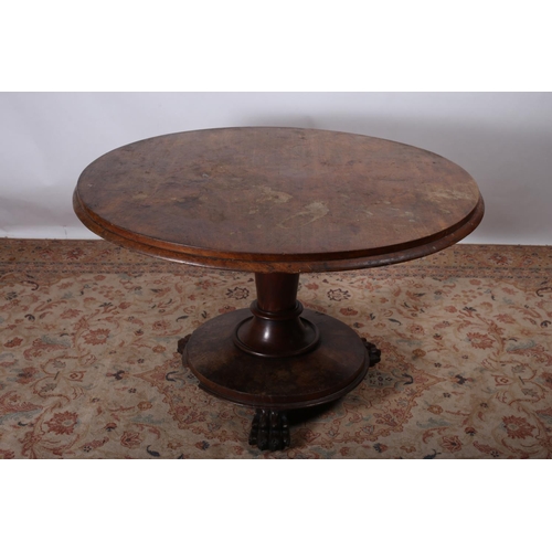 76 - A 19TH CENTURY MAHOGANY POD TABLE of oval outline the shaped top above a cylindrical column on platf... 