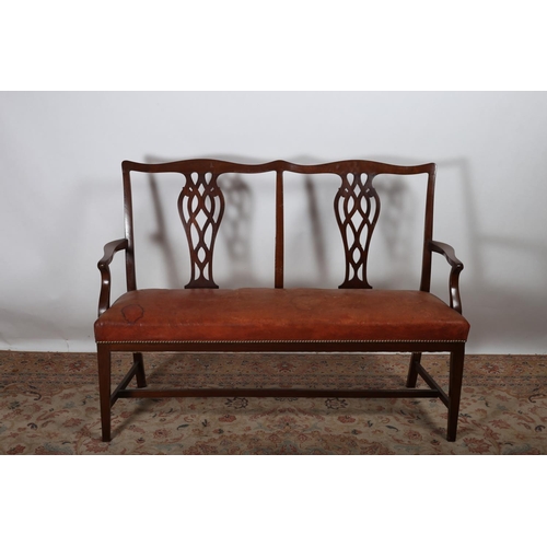 77 - A CHIPPENDALE DESIGN MAHOGANY AND HIDE UPHOLSTERED DOUBLE CHAIR BACK SETTEE the serpentine top rail ... 