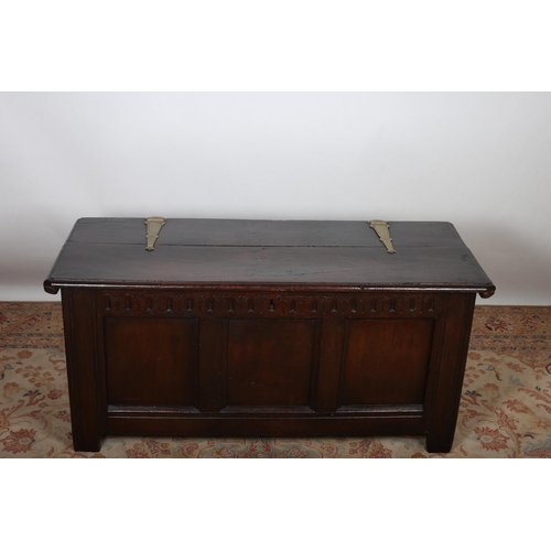 81 - A GEORGIAN OAK COFFER OF RECTANGULAR OUTLINE the hinged lid with brass strap hinges and panelled fri... 