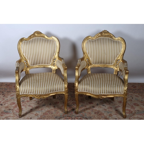 84 - A PAIR OF 19TH CENTURY GILTWOOD AND UPHOLSTERED ARMCHAIRS each with a foliate carved shaped top rail... 