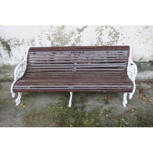 851 - A 19TH CENTURY CAST IRON GARDEN BENCH the slatted back and seat with pierced foliate and C-scroll ar... 